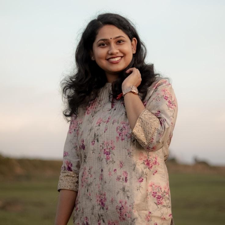 Anaya Singh, Lead Design Curator at NeatStudioHall, reviewing corporate floral arrangements